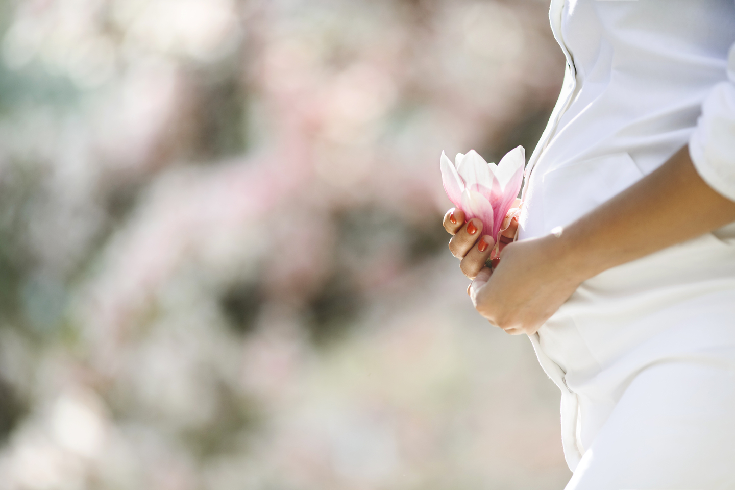 belly of a pregnant woman and a flower