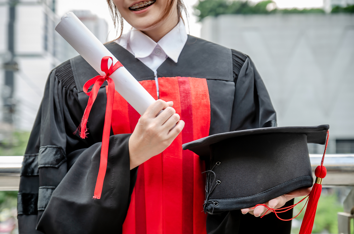 happy university students woman holding graduation diploma